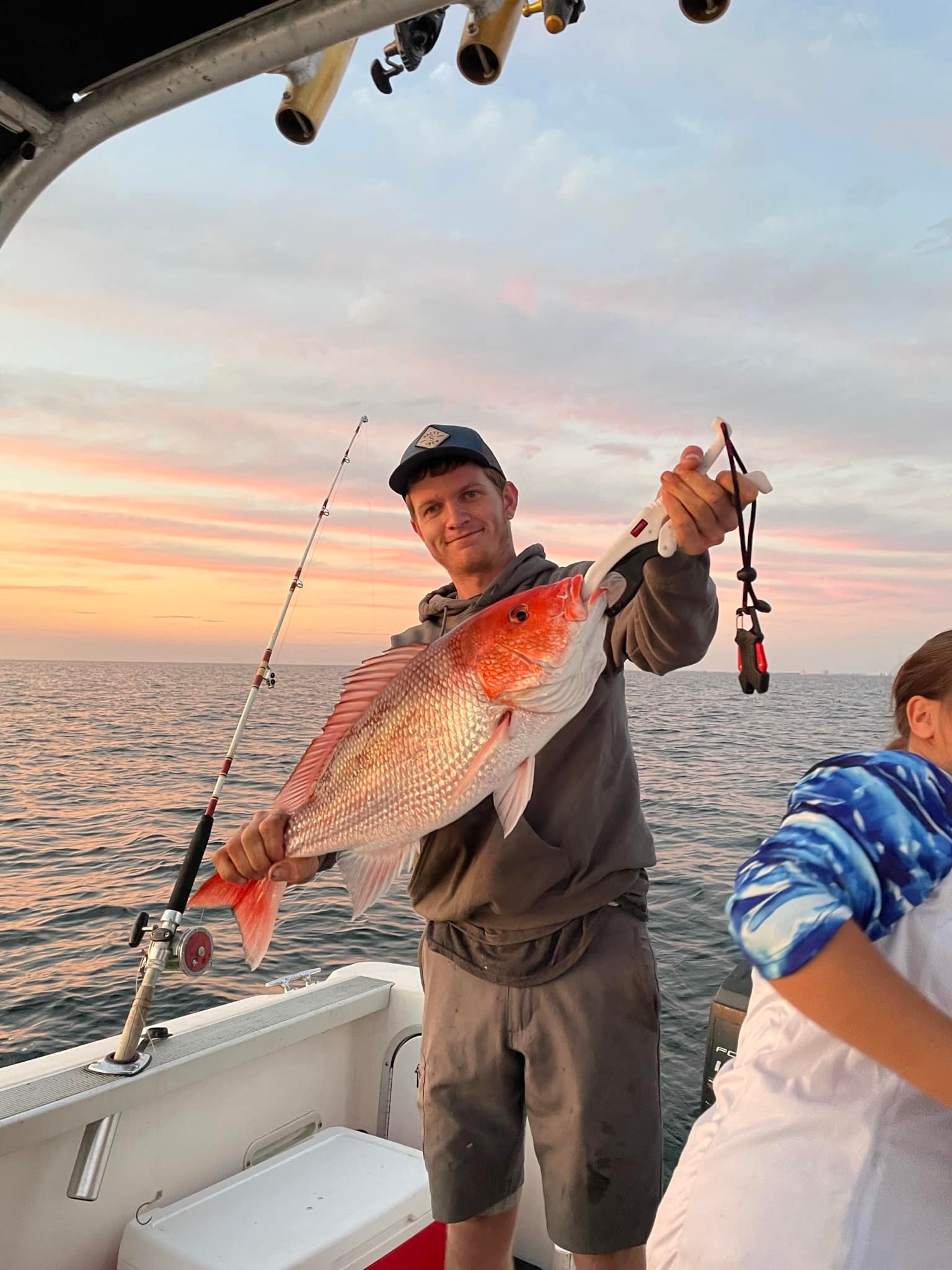 Red snapper fishing catch displayed on boat during sunset