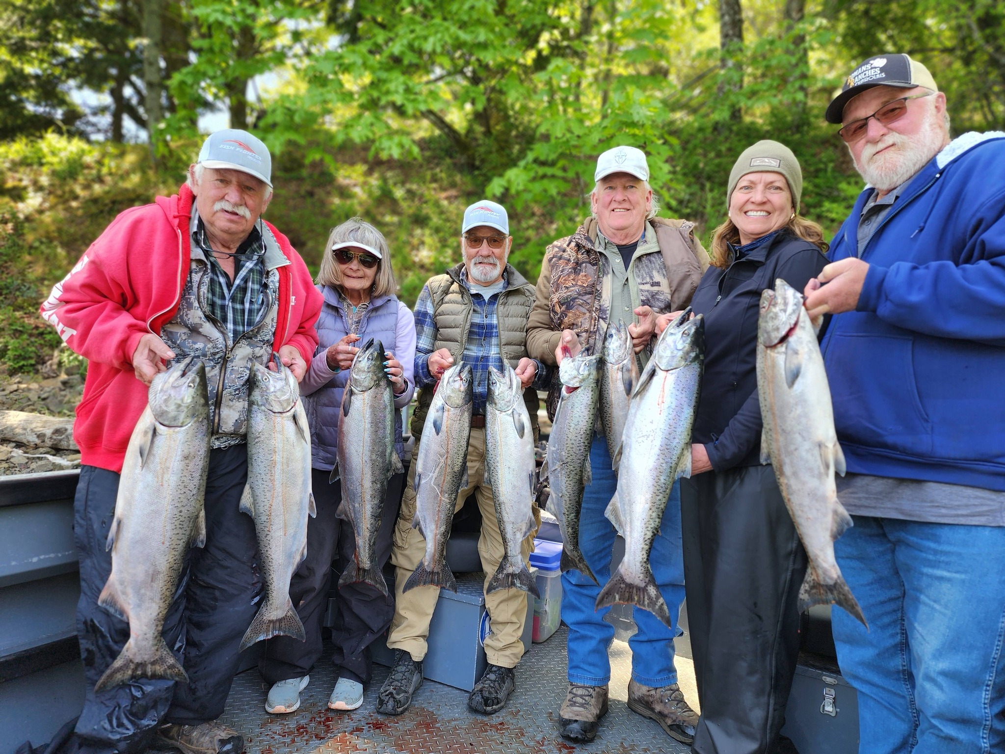Group of anglers displaying fresh caught Chinook salmon on fishing boat in Kennewick WA
