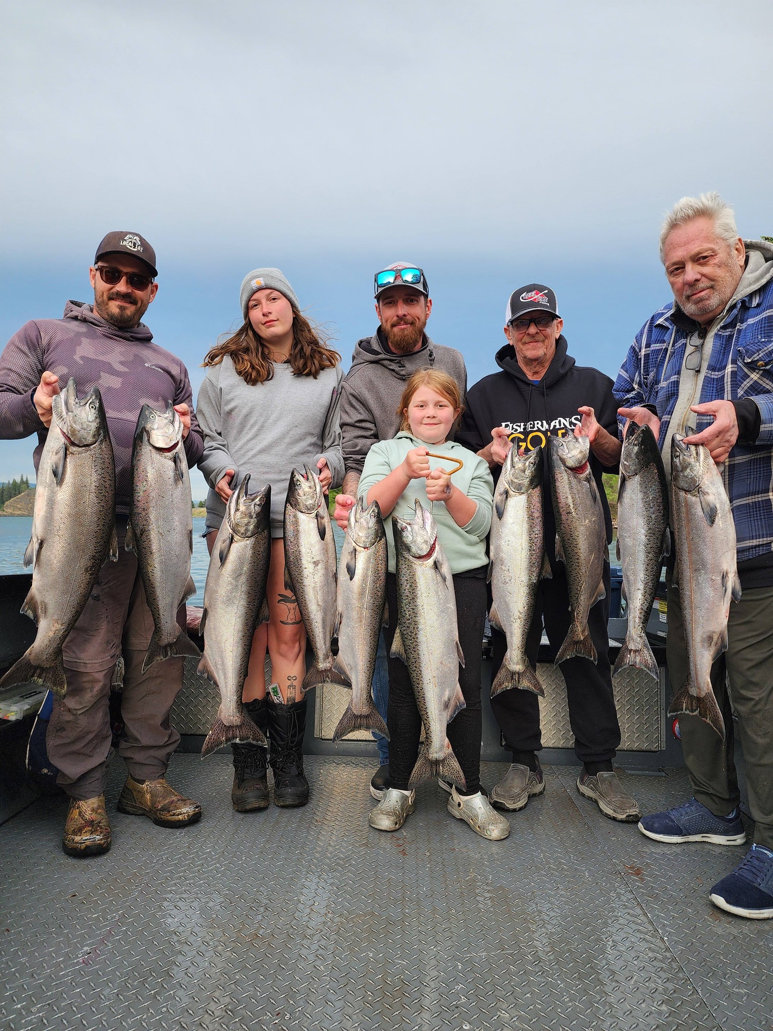 Group displaying fresh caught Chinook salmon on boat deck in Kennewick WA