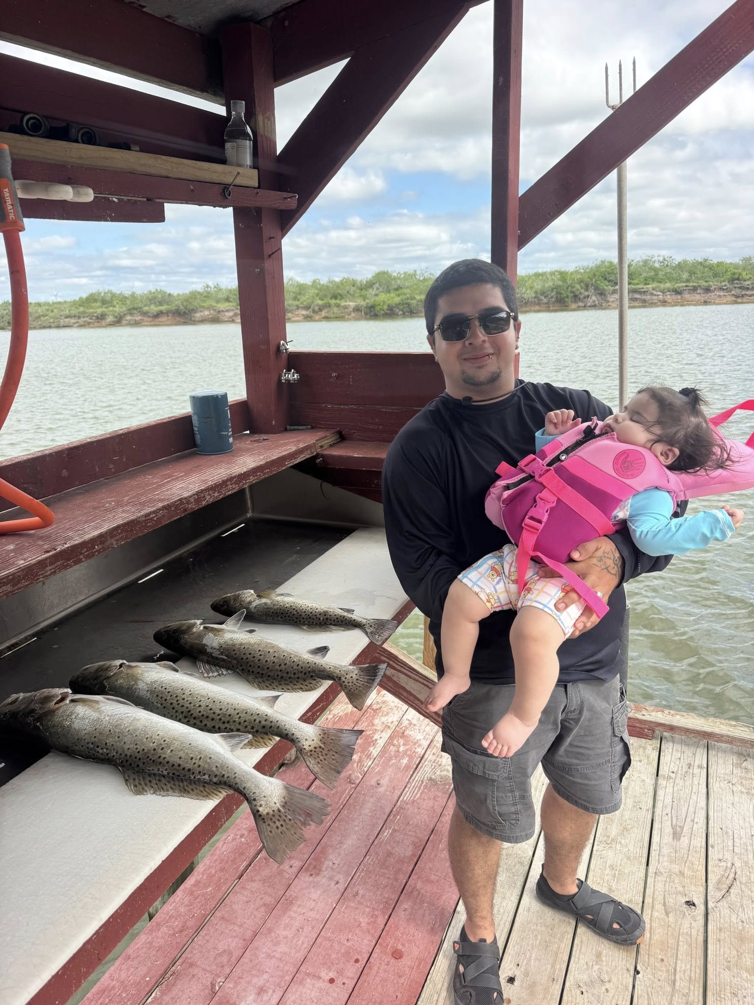 Successful speckled trout fishing trip in Arroyo City TX with multiple fish displayed on boat deck