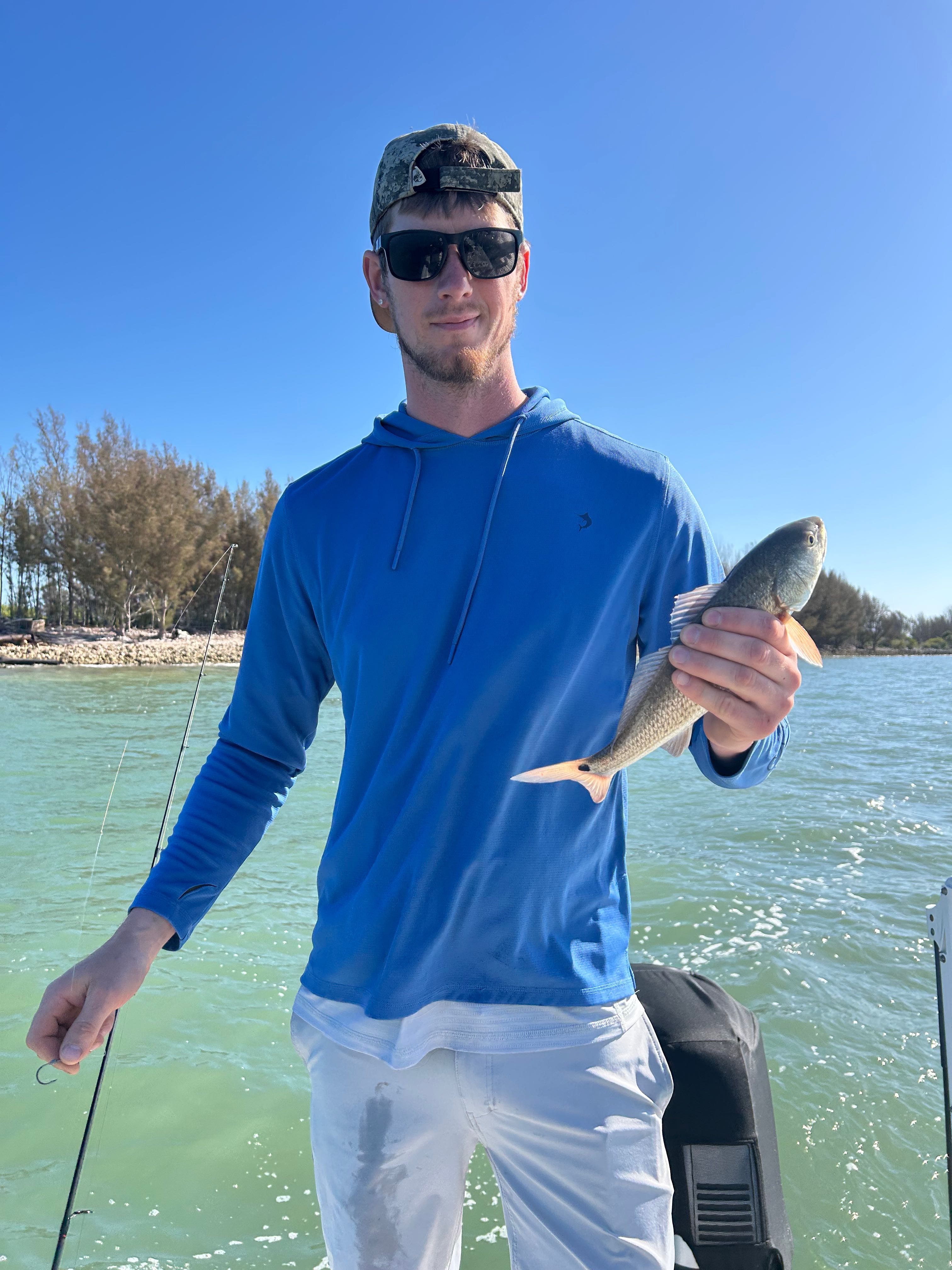 Angler holding caught redfish on fishing charter boat in Crystal River Florida
