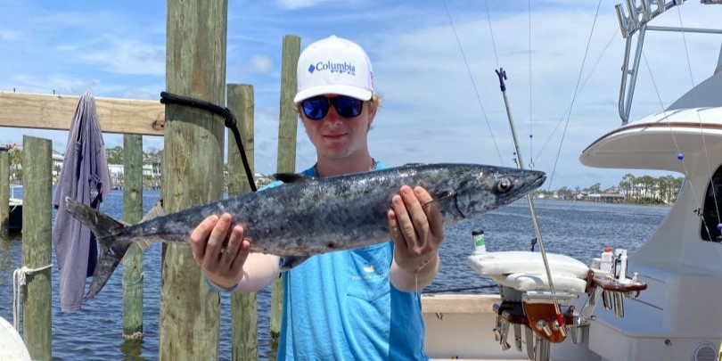 A person fishing with a rod at Orange Beach