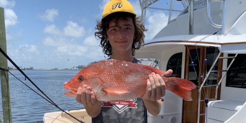 Angler fishing in Alabama with rod and reel