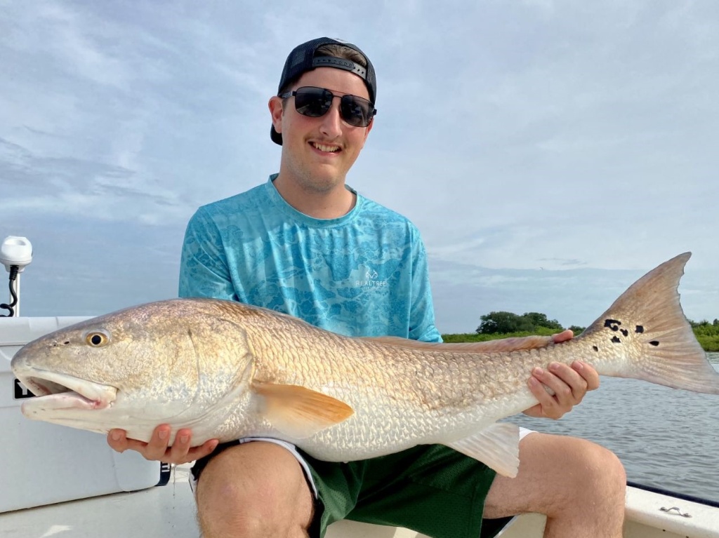 A person holding a 33-inch fish in FL.