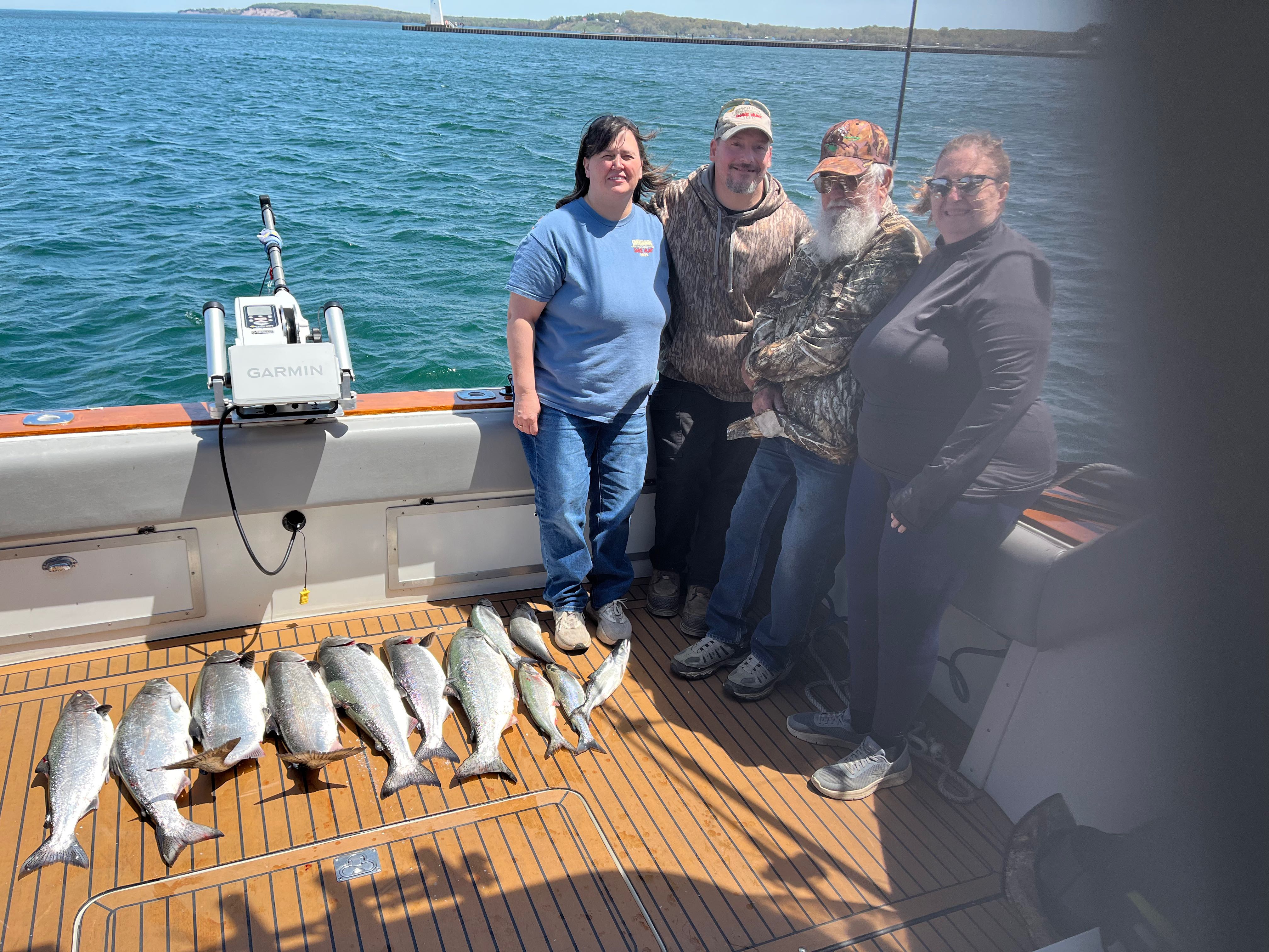 Successful coho salmon fishing trip at Sodus Point NY with multiple fish displayed on boat deck