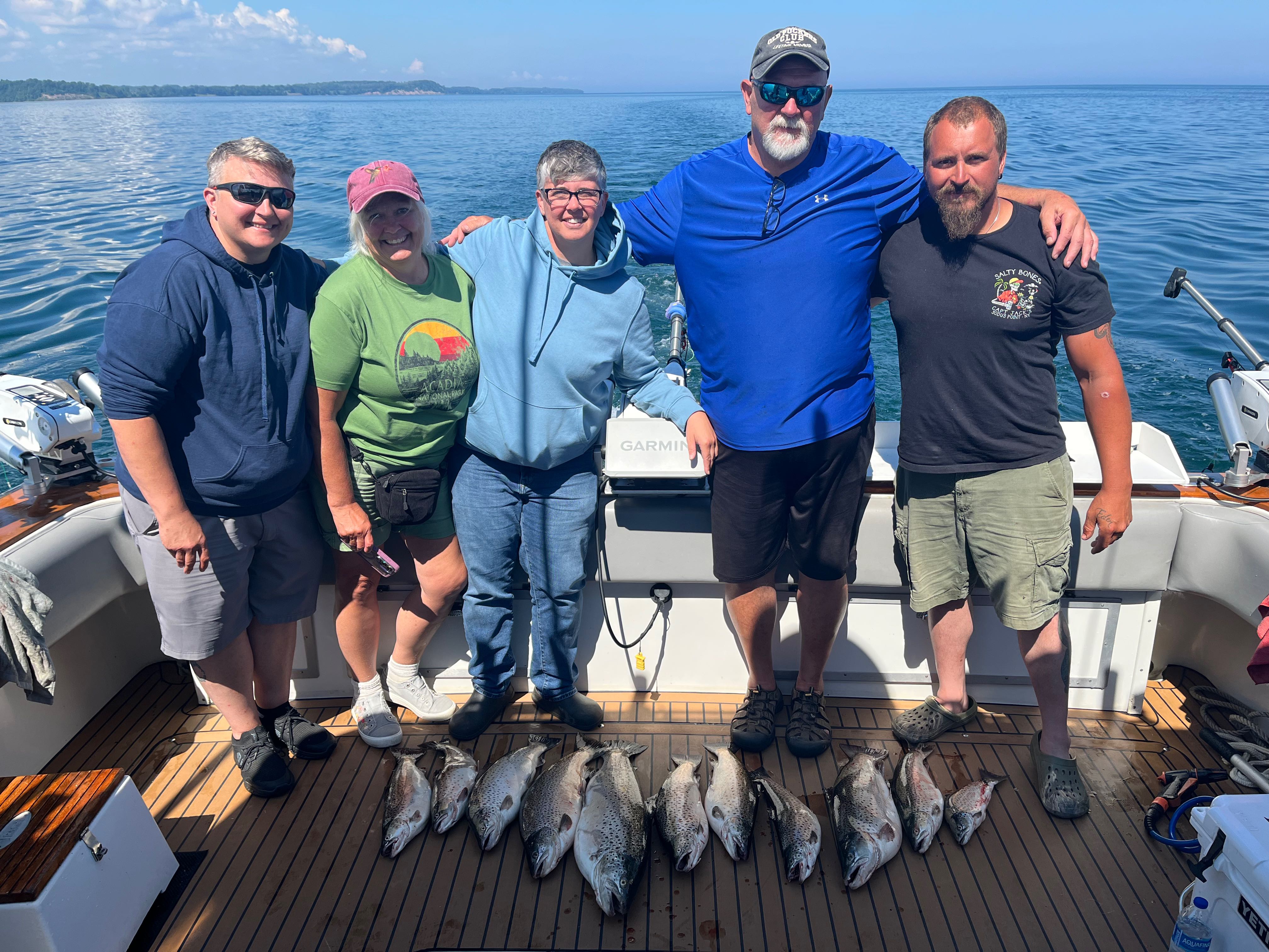 Group of anglers with their catch of fish on boat deck at Sodus Point NY