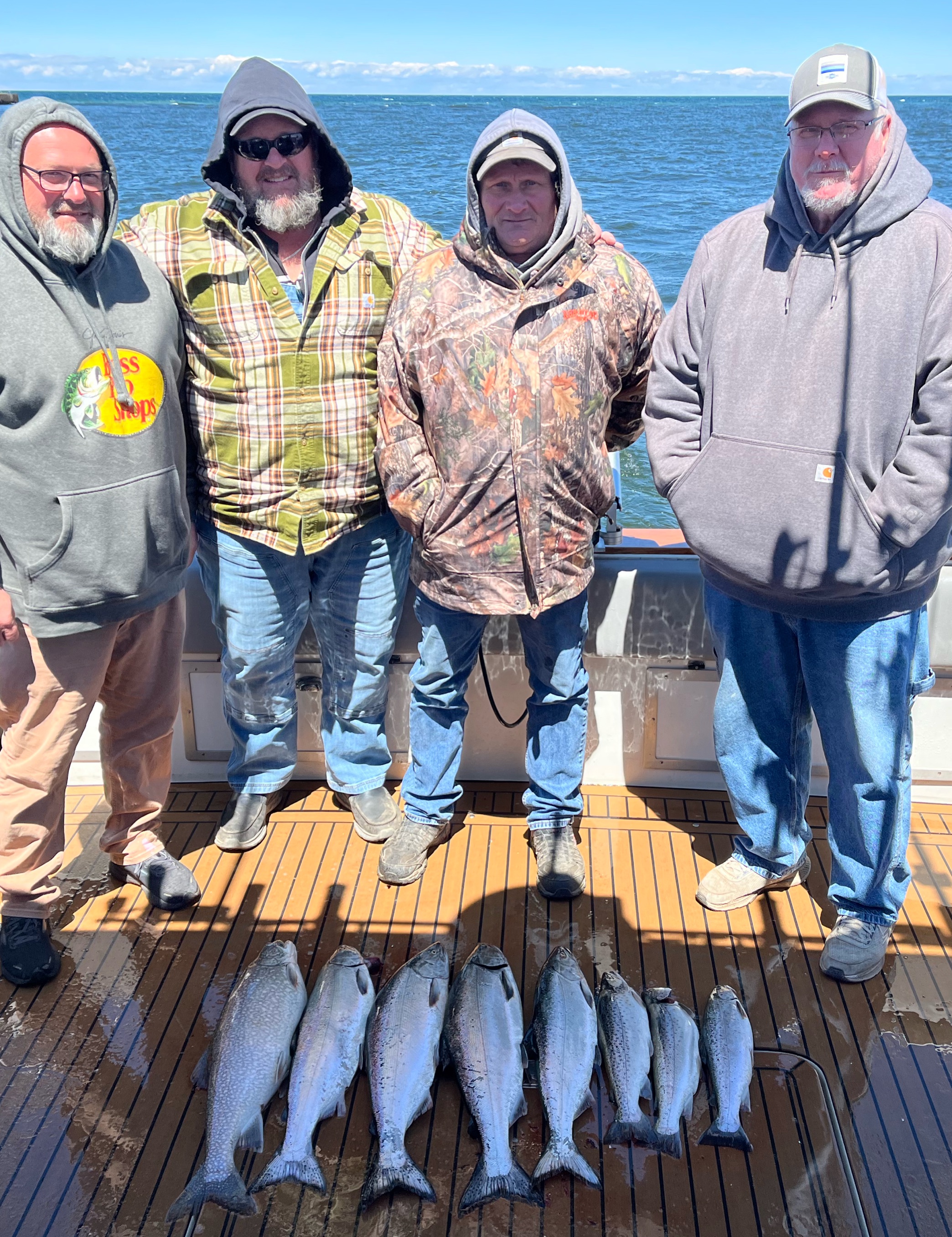 Successful fishing trip at Sodus Point NY with Lake Trout, Chinook Salmon, and Coho Salmon displayed on boat deck