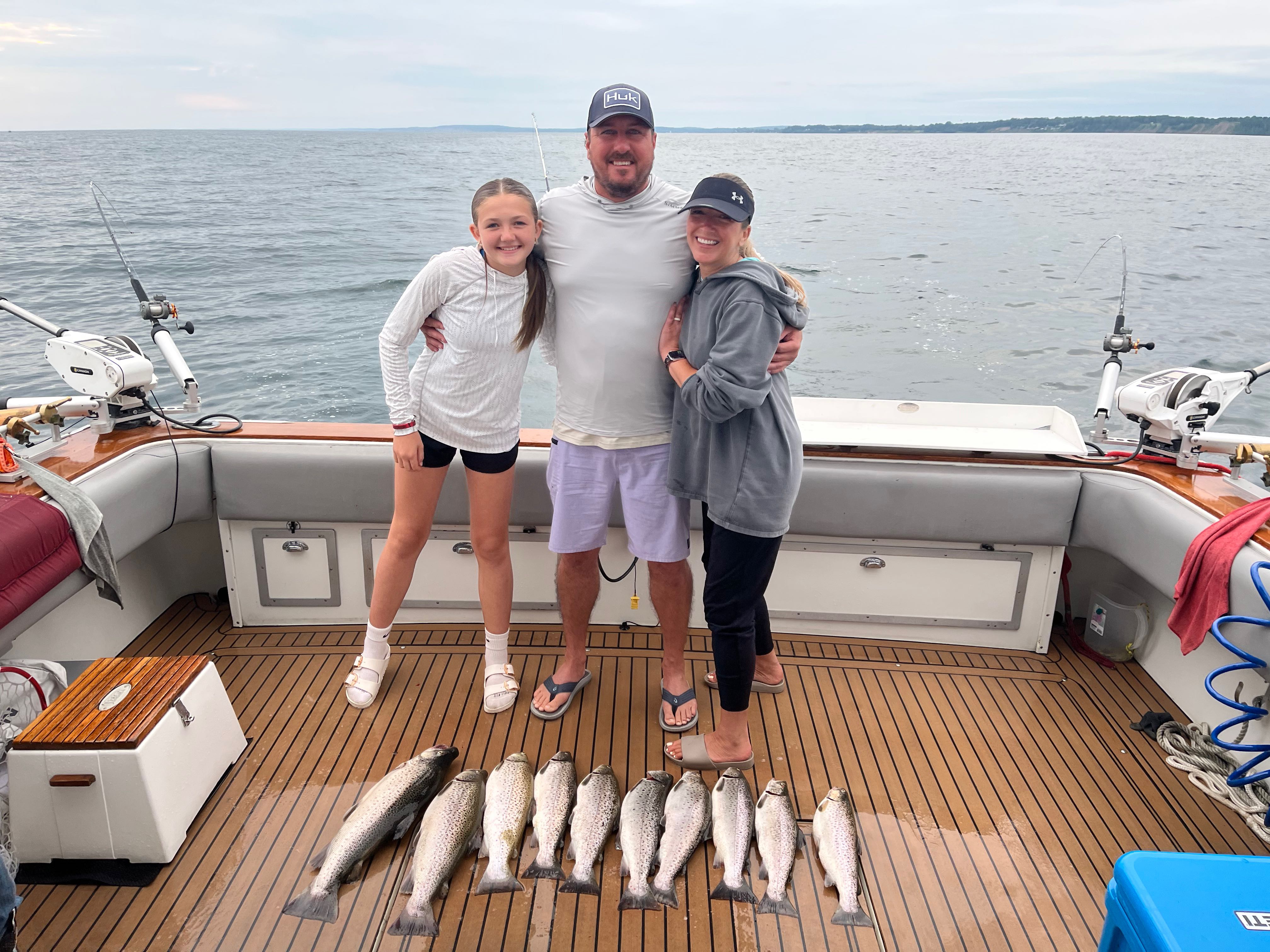 Fishing charter displaying catch of brown trout and rainbow trout on boat deck at Sodus Point NY