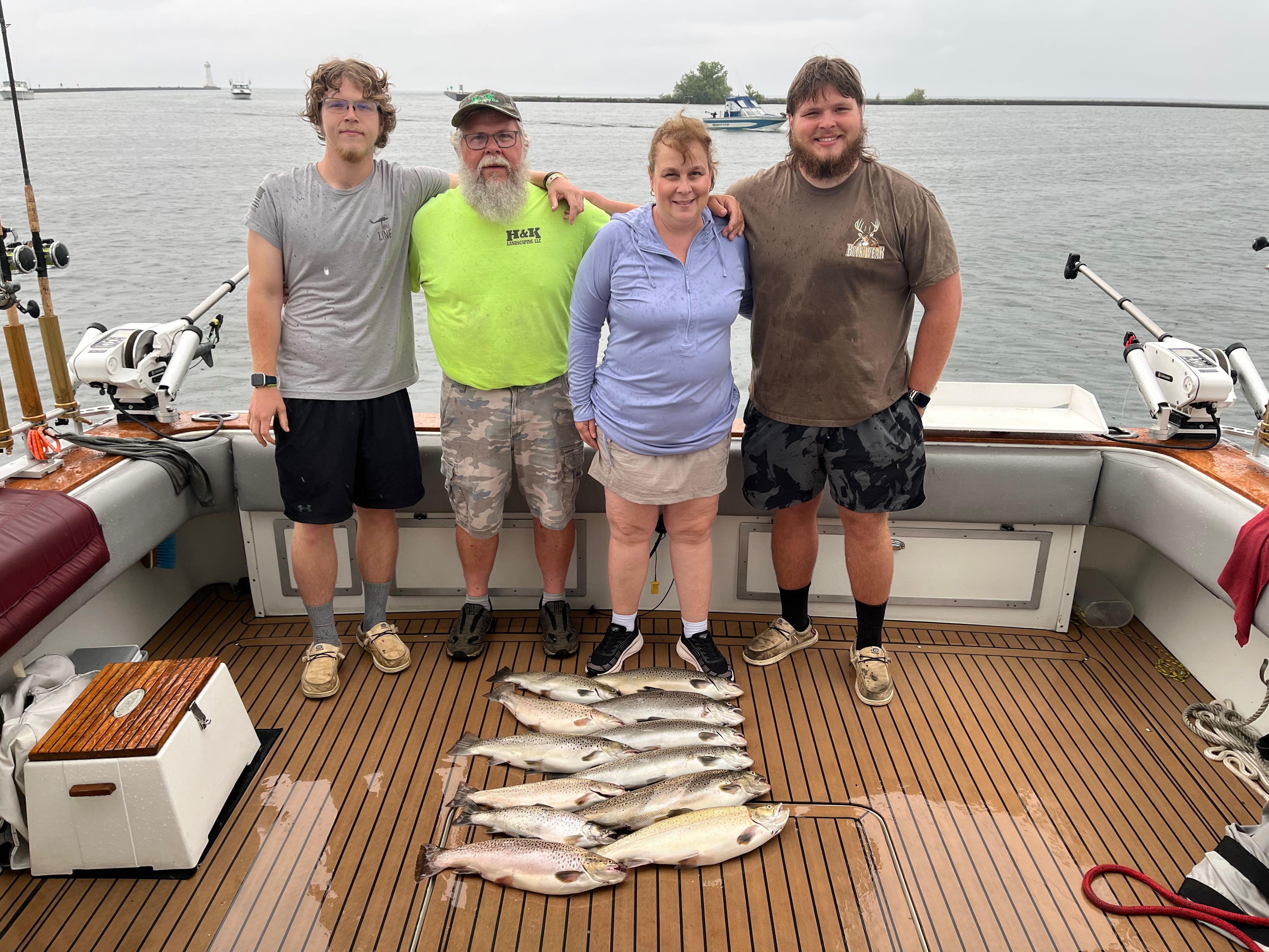 Successful fishing trip displaying caught brown trout and Atlantic salmon on boat deck at Sodus Point NY