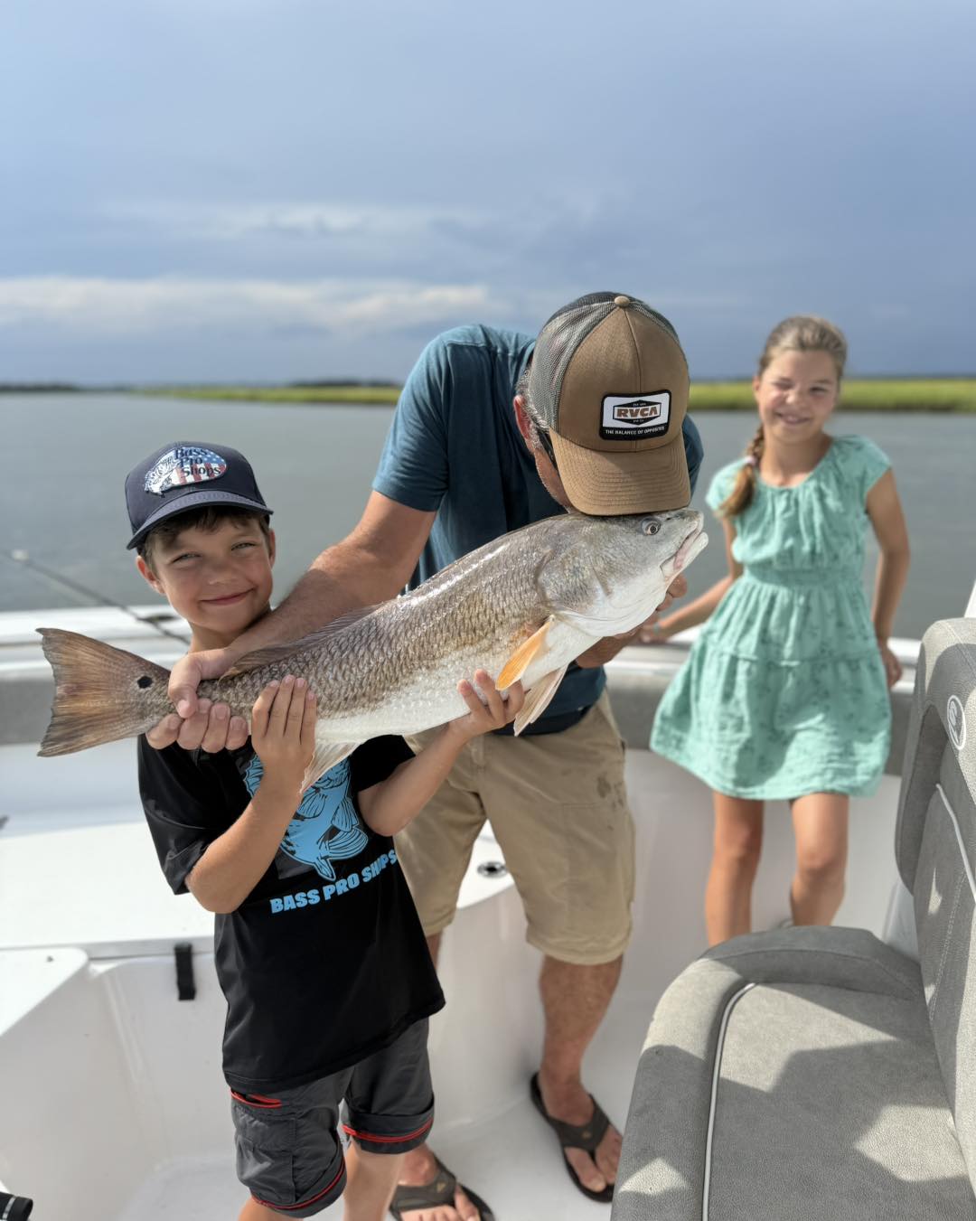 A couple fishing for a Black Drum fish in South Carolina