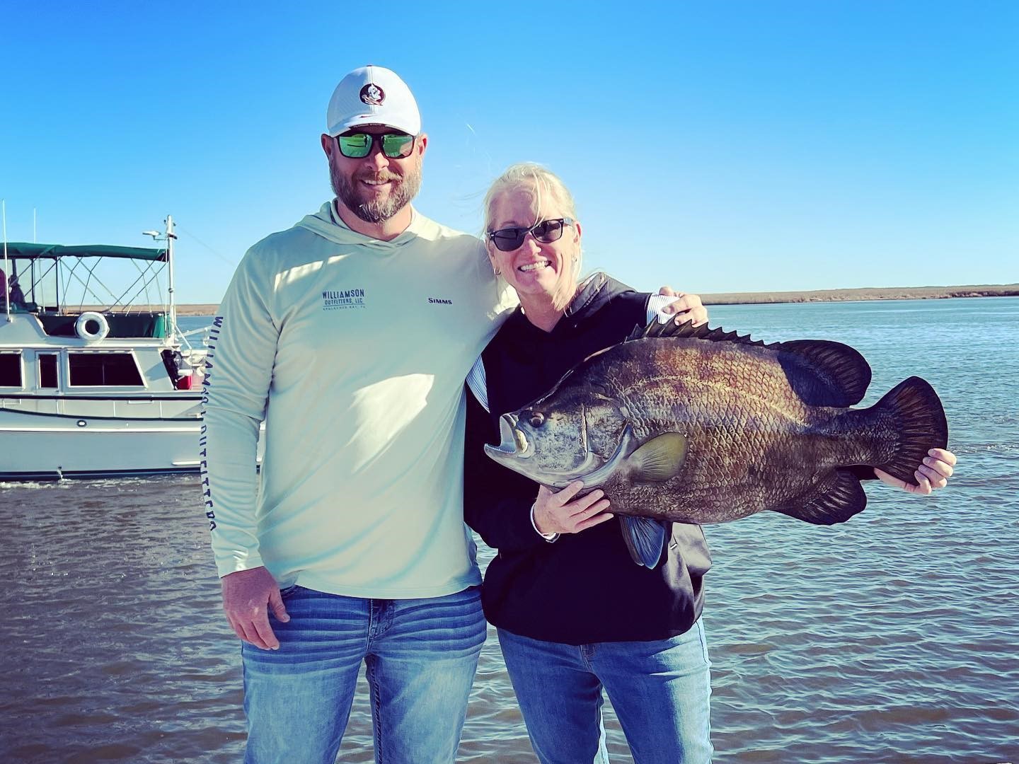 Two people fishing with a big 24-inch fish in Apalachicola