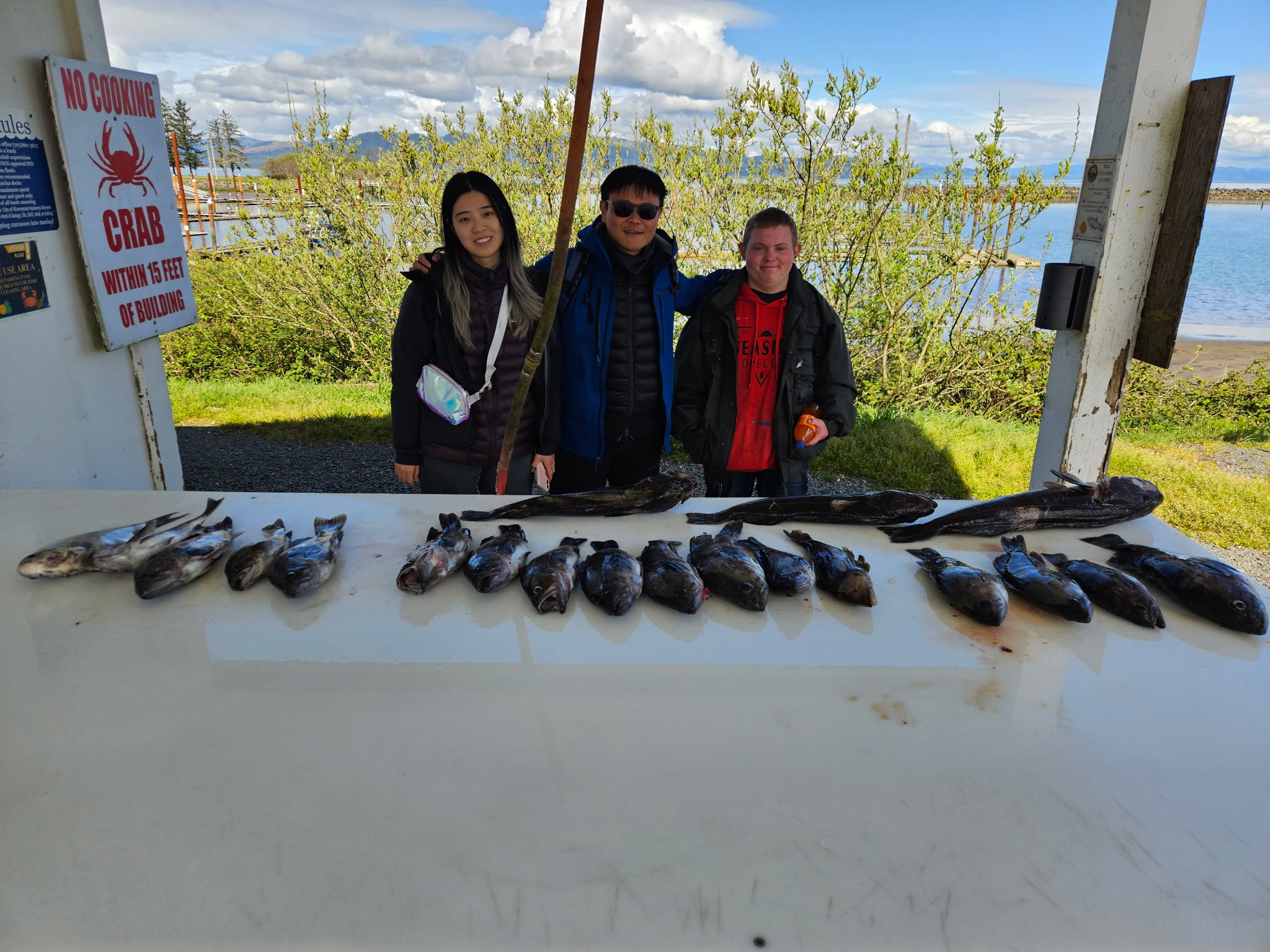Lingcod and rockfish fishing charter boat in Astoria waters with anglers reeling in catch