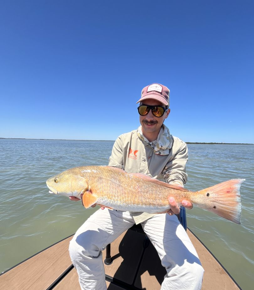 A lone fisherman reeling in a catch in TX