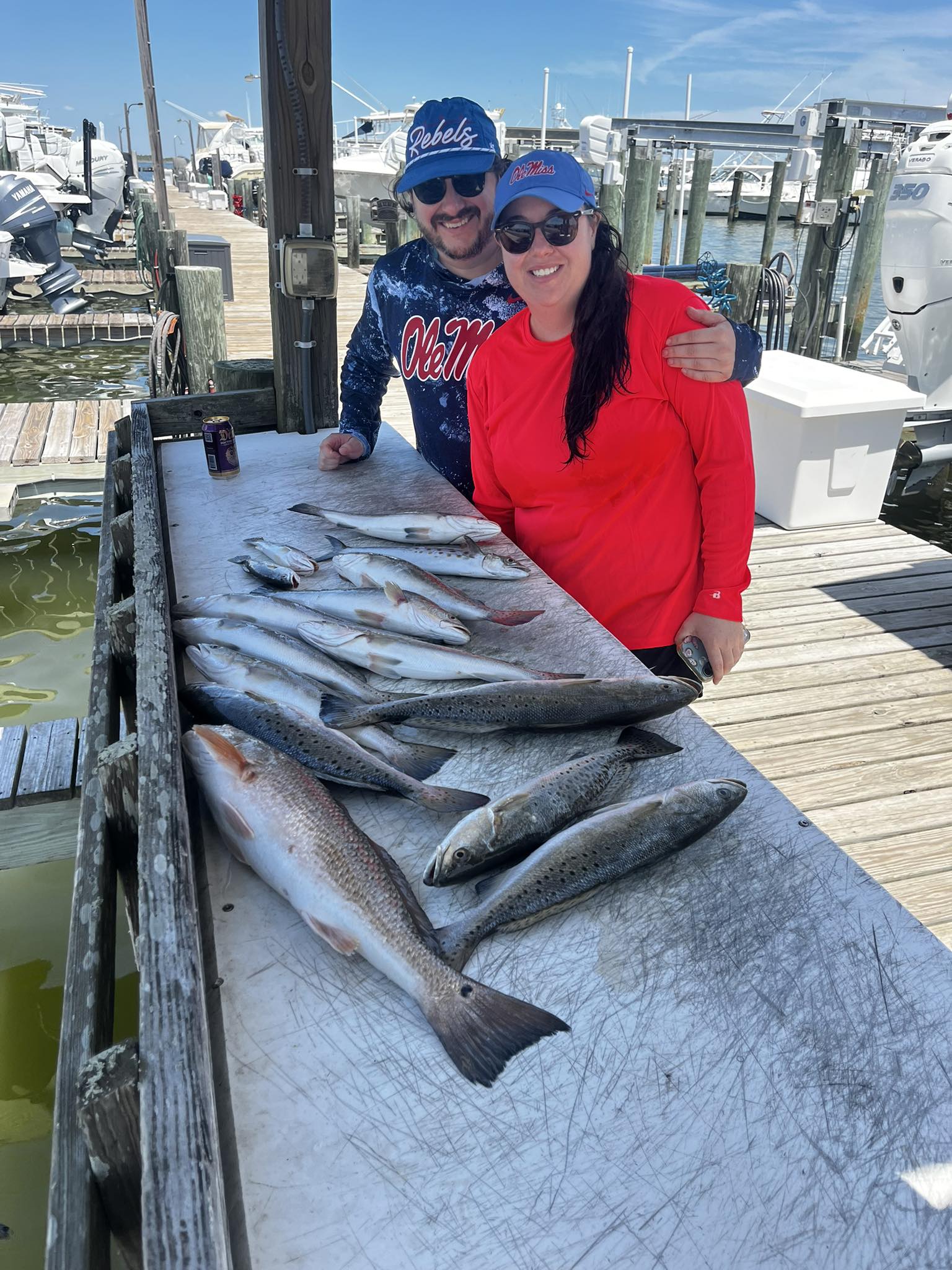 Successful fishing trip displaying redfish and speckled trout catch on dock at Dauphin Island AL