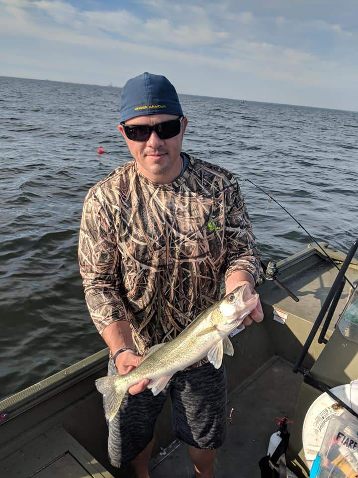 Two anglers fishing in MI with one fish