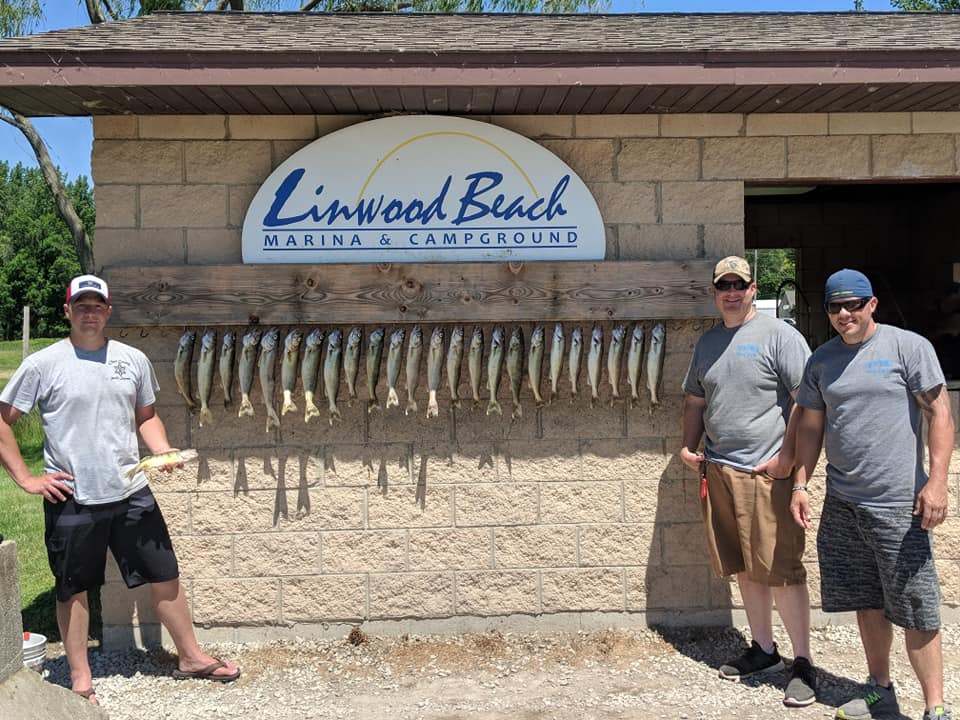Three people enjoying a day by the water at Saginaw Bay
