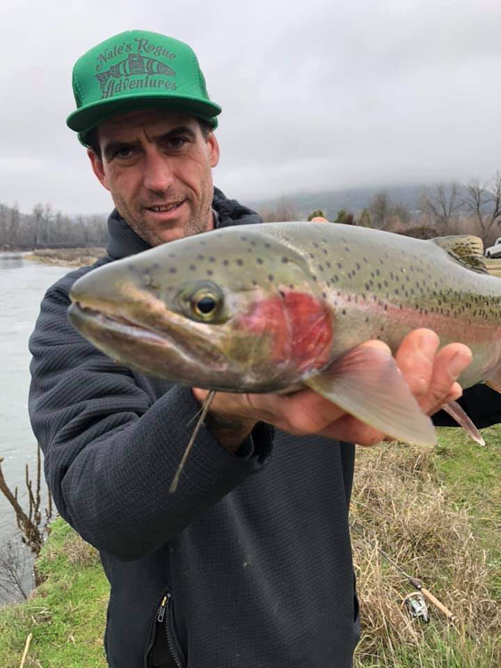 Angler catching a rainbow trout in Oregon