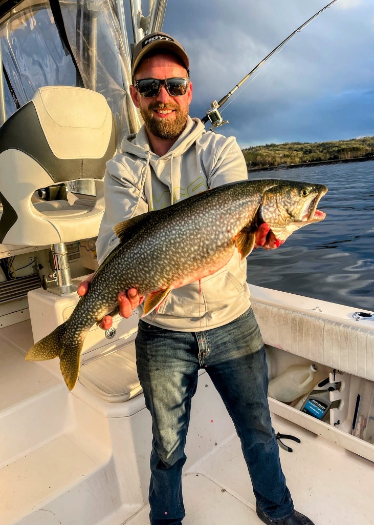 Angler reeling in a 23-inch fish in Marquette