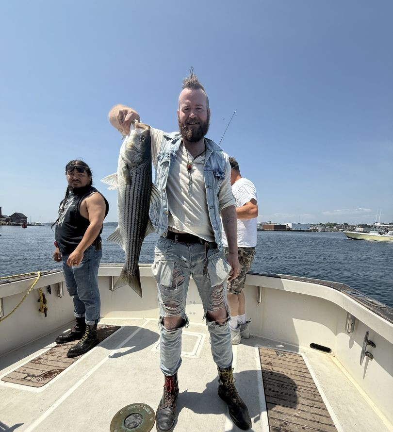 Striped bass fishing success on boat in Gloucester MA waters