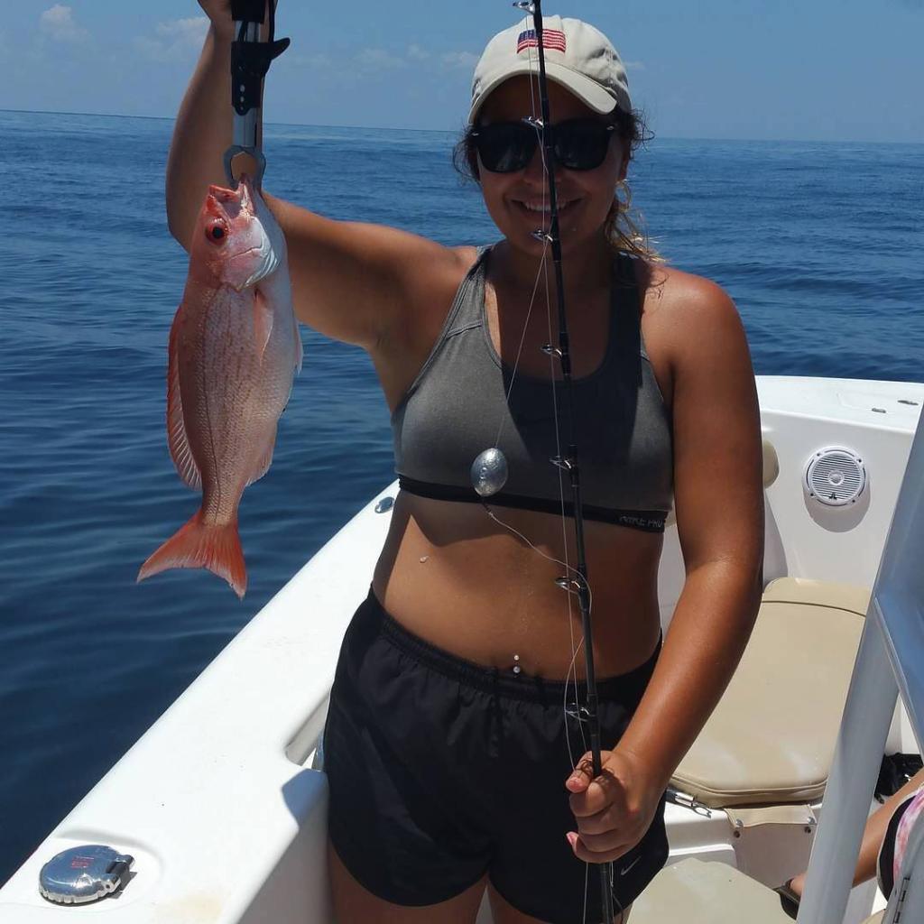 Angler posing with a freshly caught fish in St. Augustine
