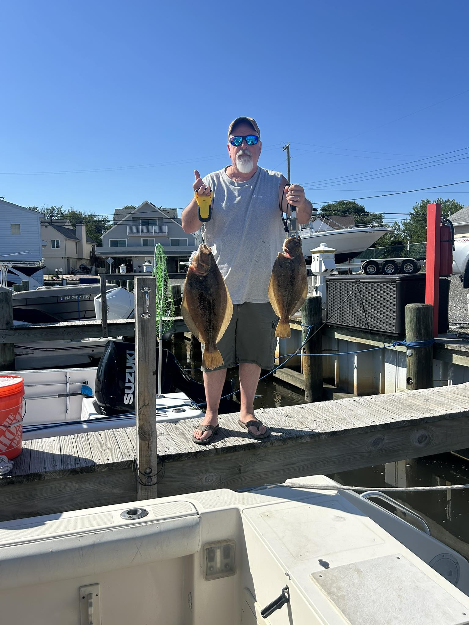 Fisherman catching 2 fish in Barnegat