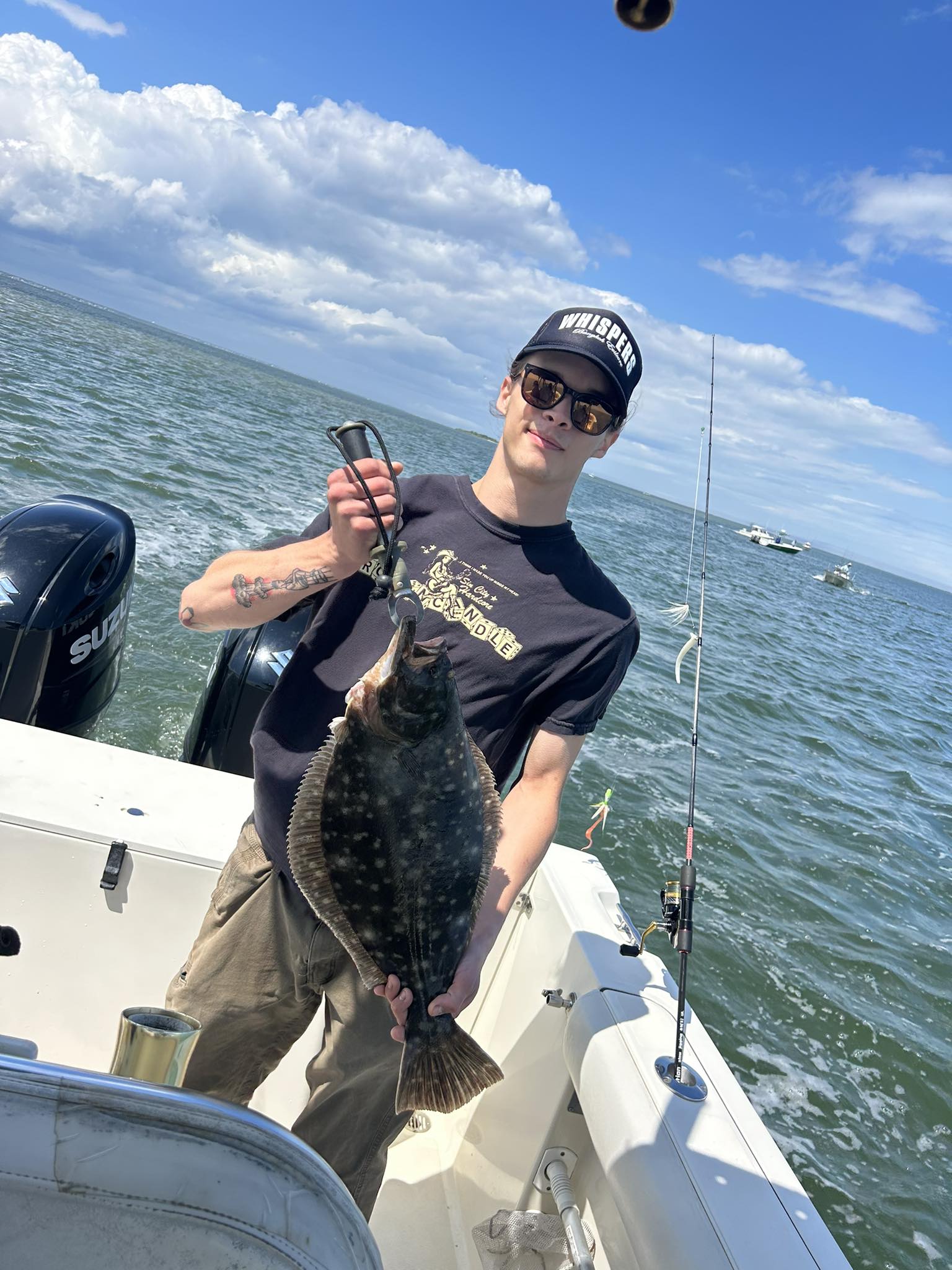 A person fishing for a summer flounder in NJ
