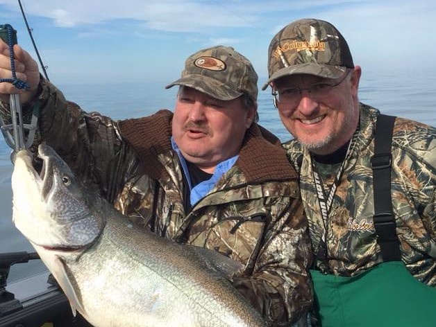 Two anglers with big fish in Erie