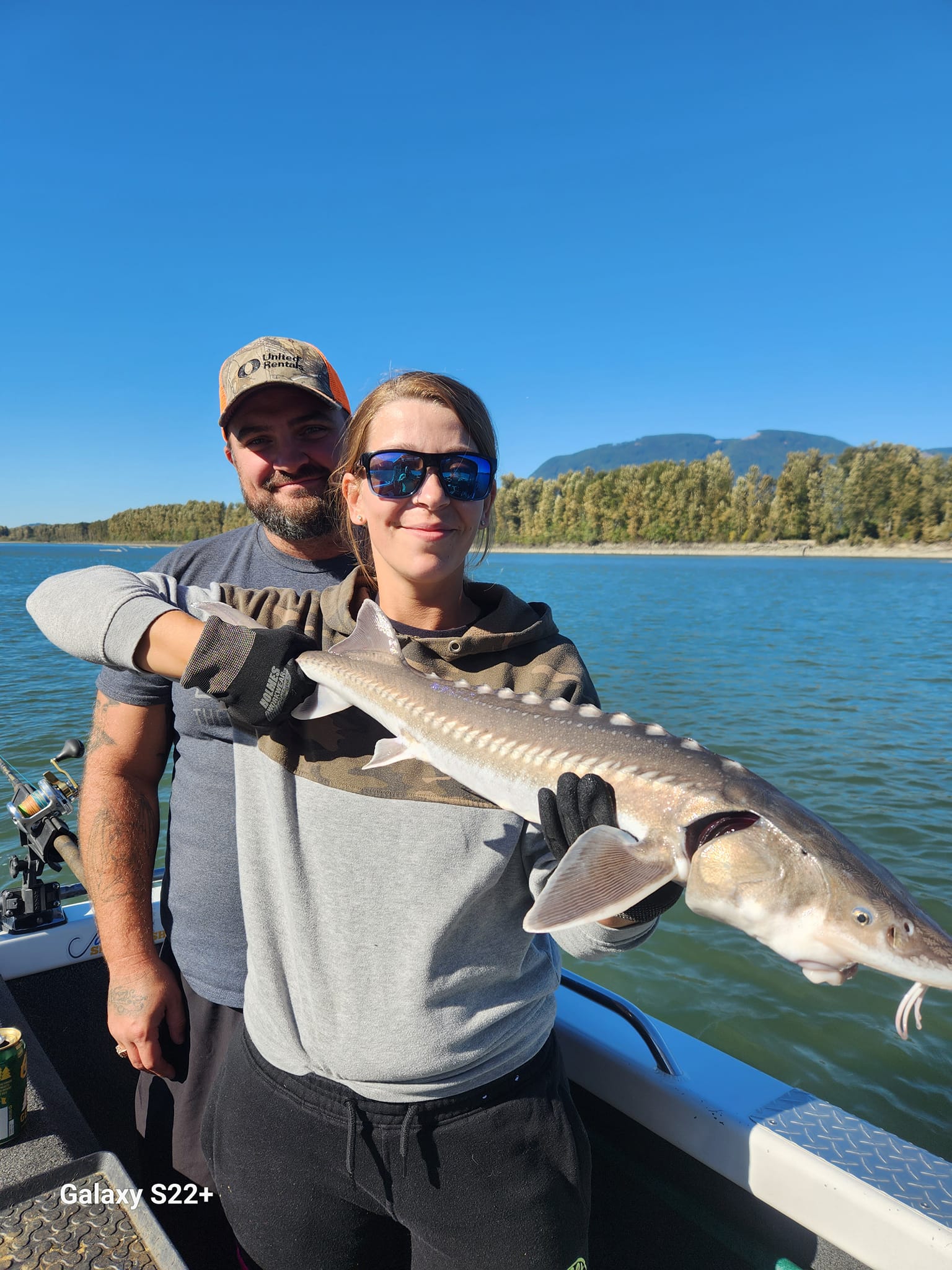 Photograph of a white sturgeon fish being caught in BC, Canada