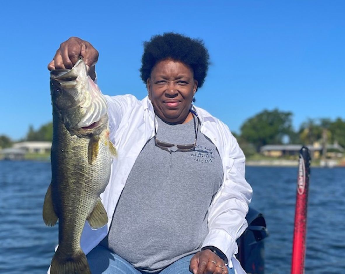 Large bass fish being held up after successful catch in Winter Haven FL