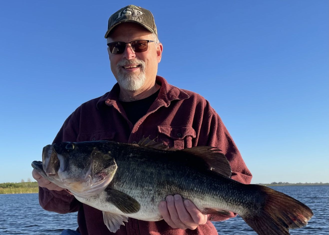 Large bass fish being held after successful catch in Winter Haven FL waters