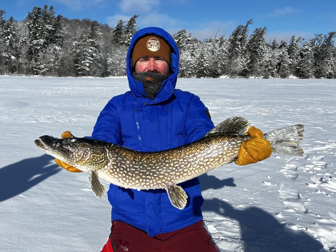 Northern pike caught ice fishing in Paul Smiths NY winter landscape