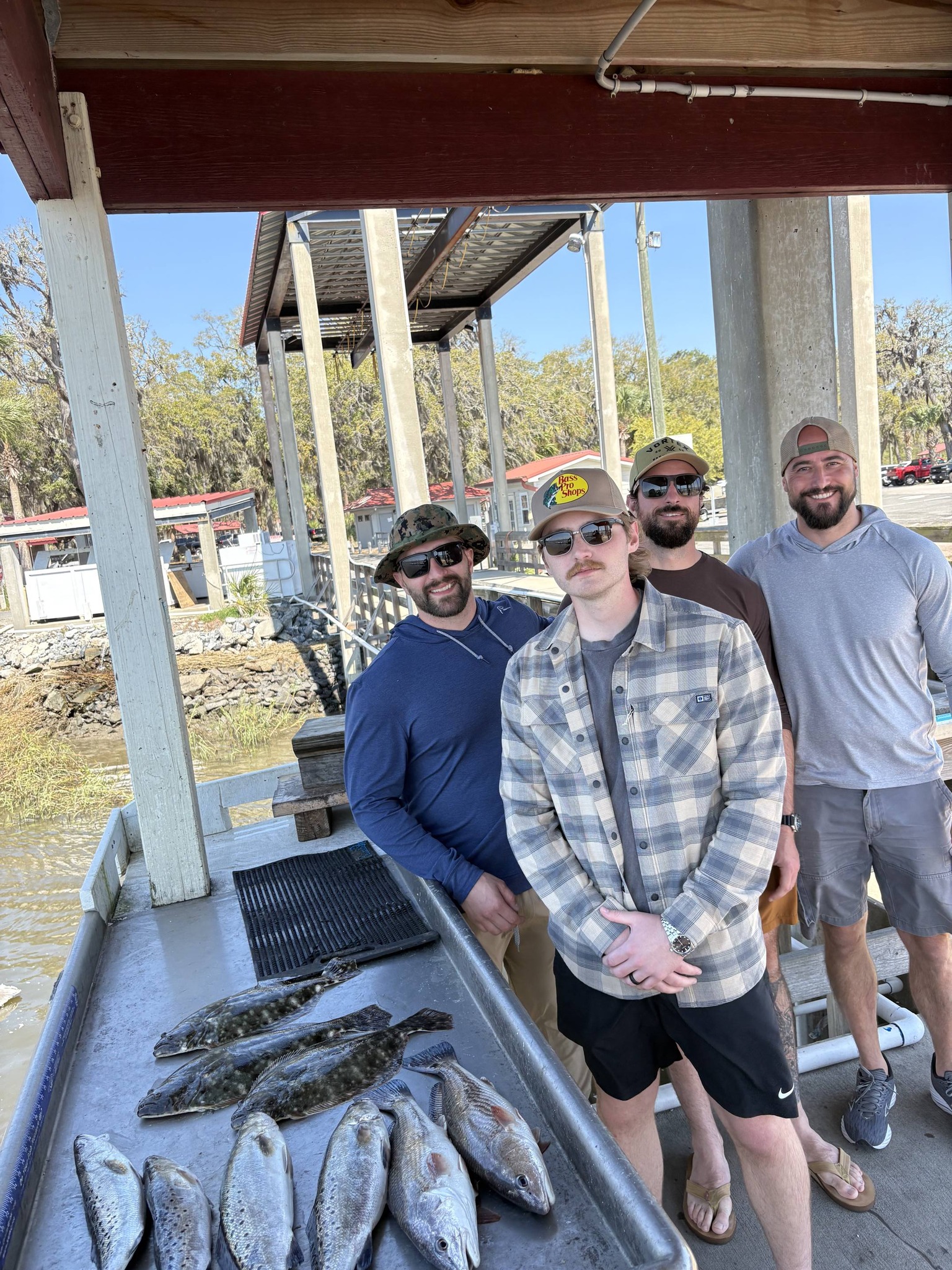 Fishing catch of redfish, southern flounder, and speckled trout displayed on boat cleaning station in Brunswick GA
