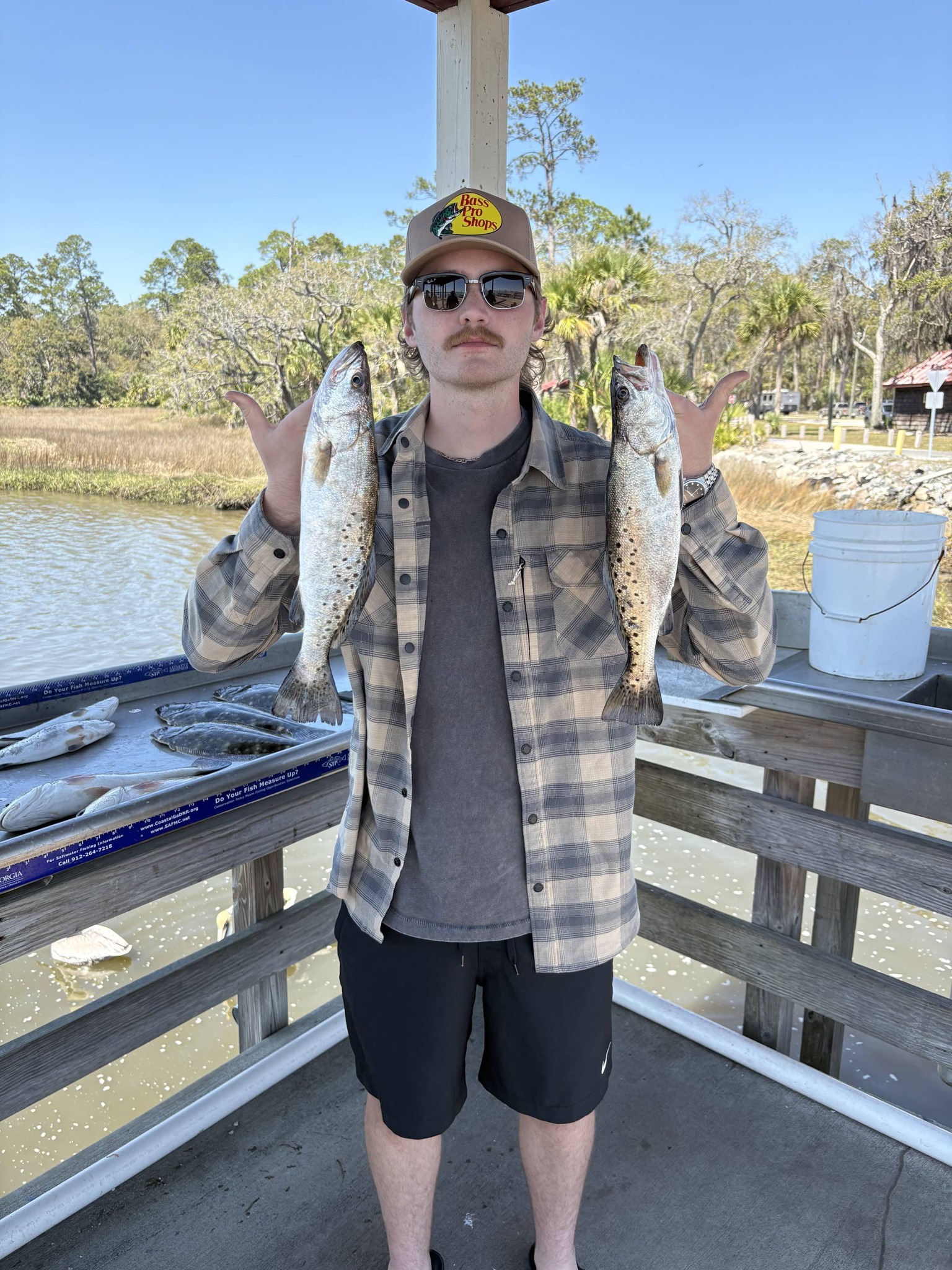 Two speckled trout caught fishing in Brunswick GA displayed on boat dock