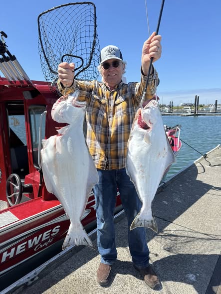 Two Pacific Halibut caught during fishing trip in Myrtle Creek OR displayed with fishing net