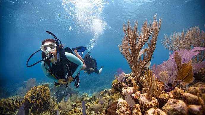 PADI Open Water Diver scuba certification course with instructor teaching underwater diving skills