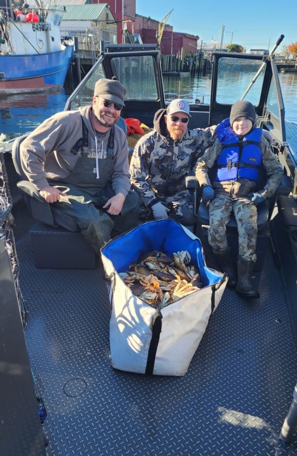Tillamook Bay crabbing and rockfish fishing charter boat with anglers catching Dungeness crab