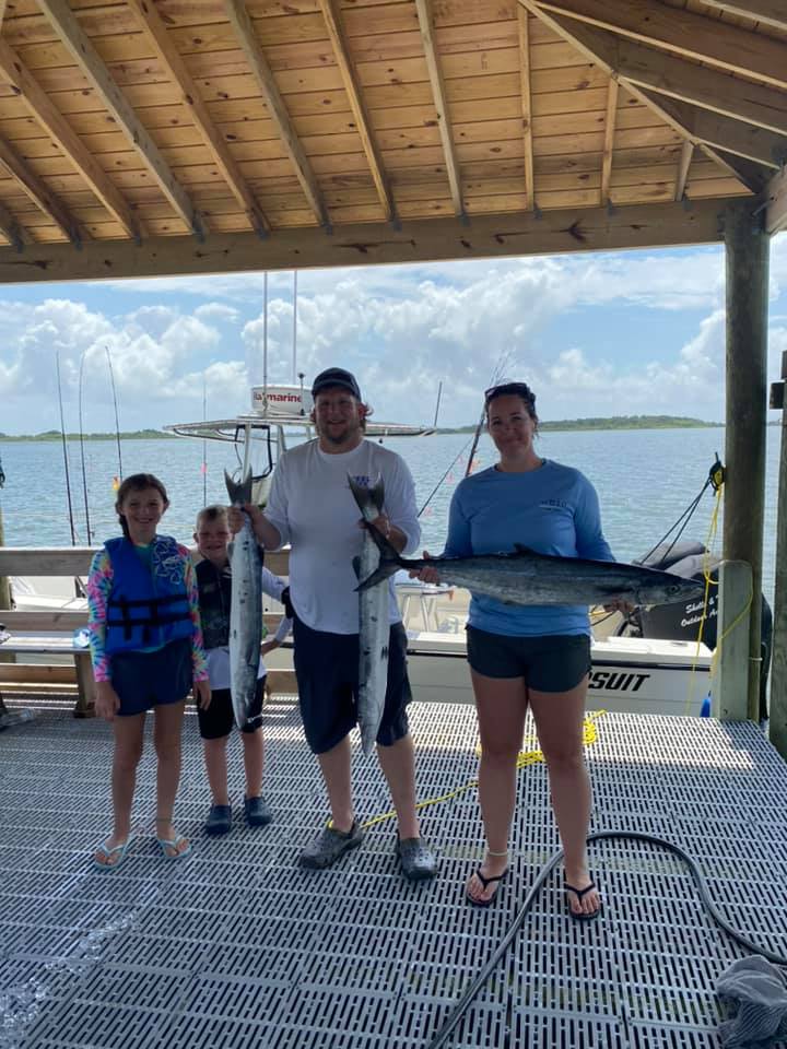 Four people fishing with two large fish at North Topsail Beach