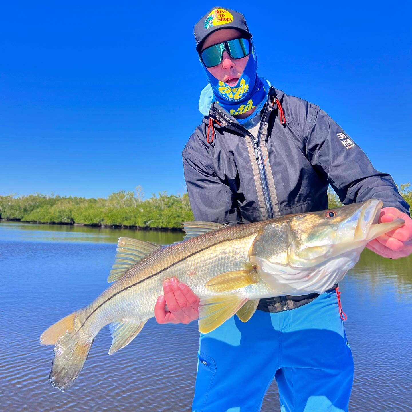 Snook caught fishing in Naples FL waters with mangroves visible in background