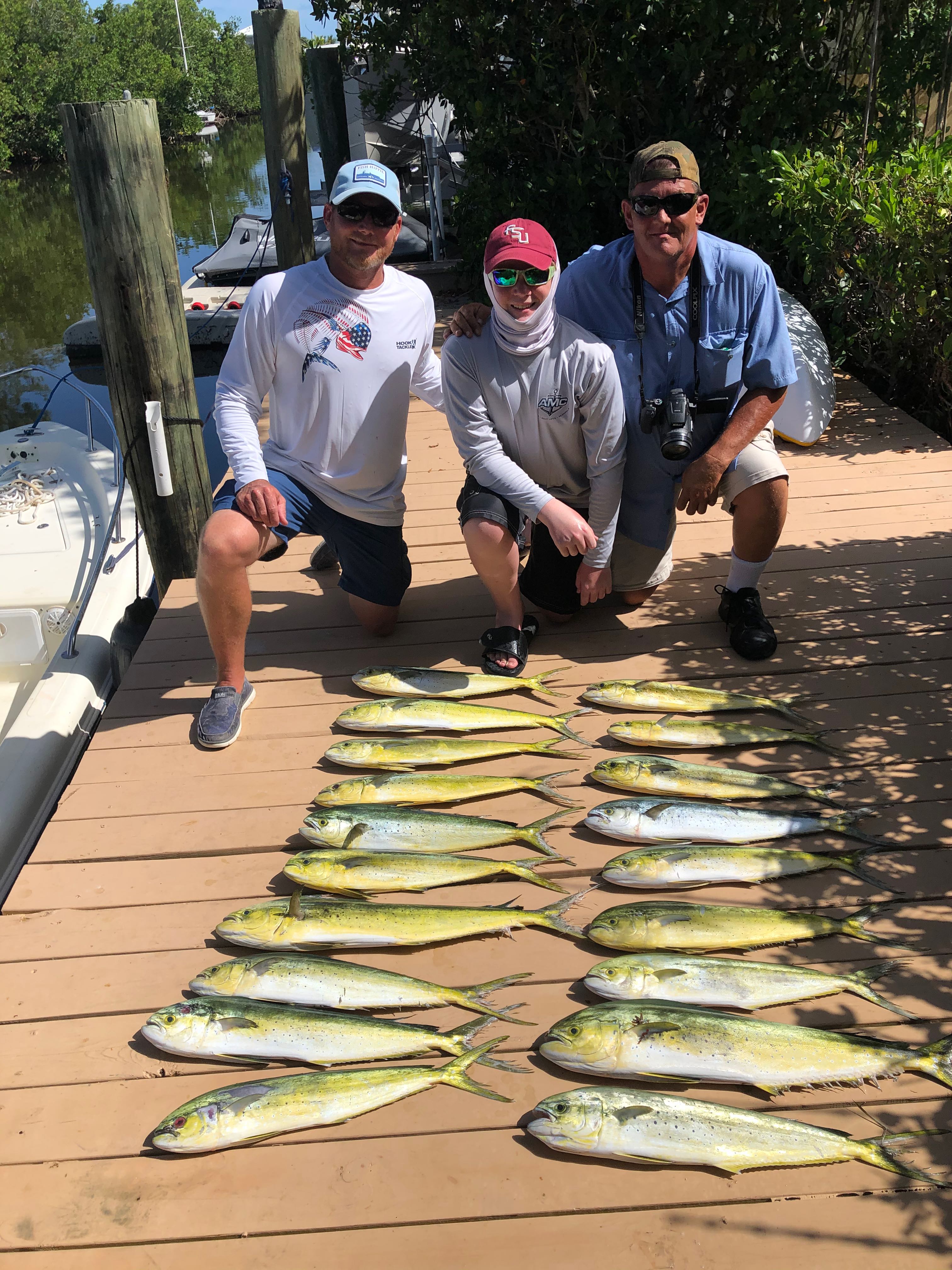 Successful mahi mahi fishing trip in Key Largo FL with multiple fish displayed on dock