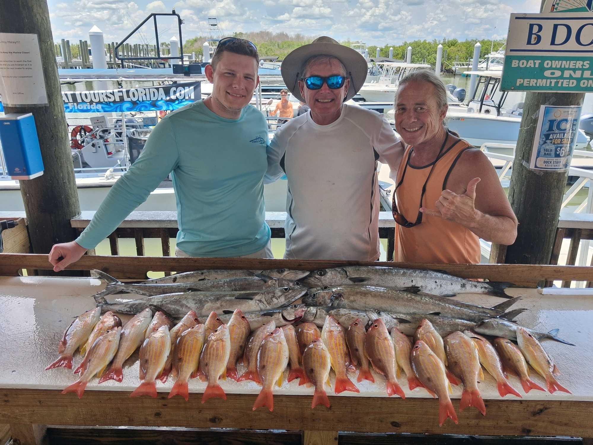 Fishing charter catch display showing lane snapper and mixed species on cleaning table at Port Orange FL marina