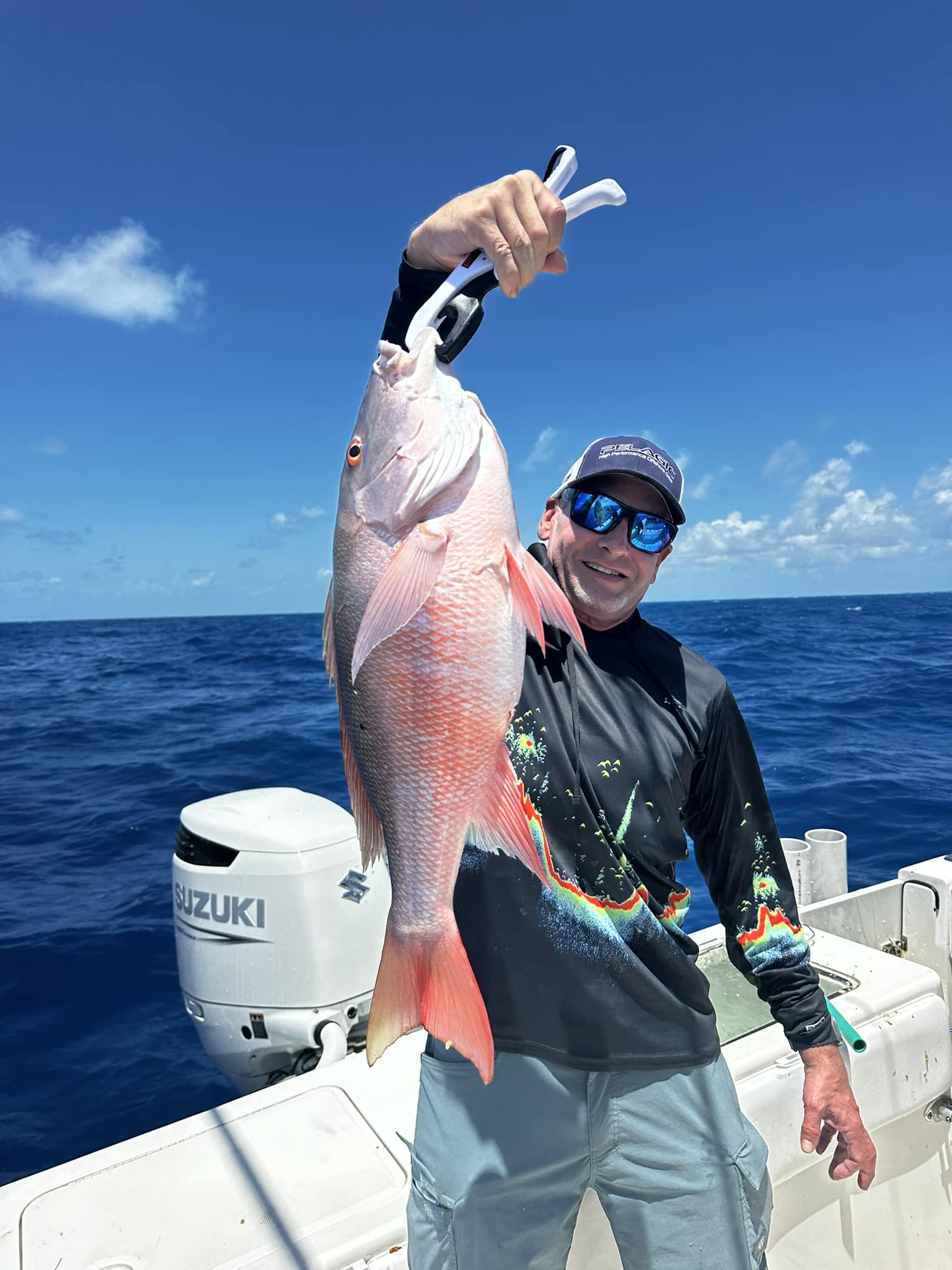 Catch of the day! Proud angler posing with a large dog snapper fish in FL.