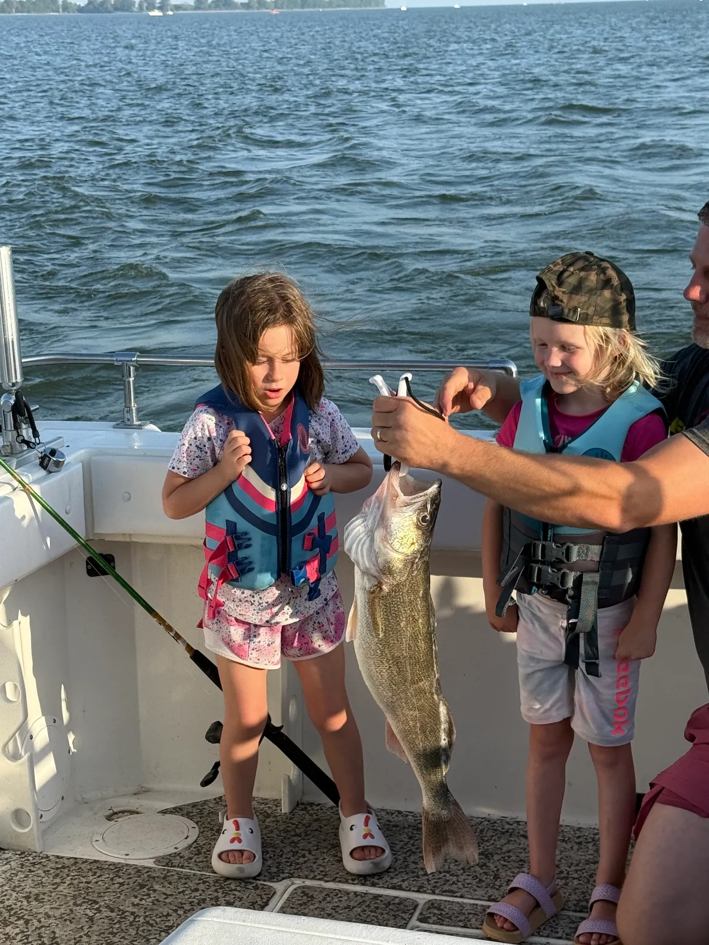 Walleye fishing success on boat in Oak Harbor OH with large caught fish