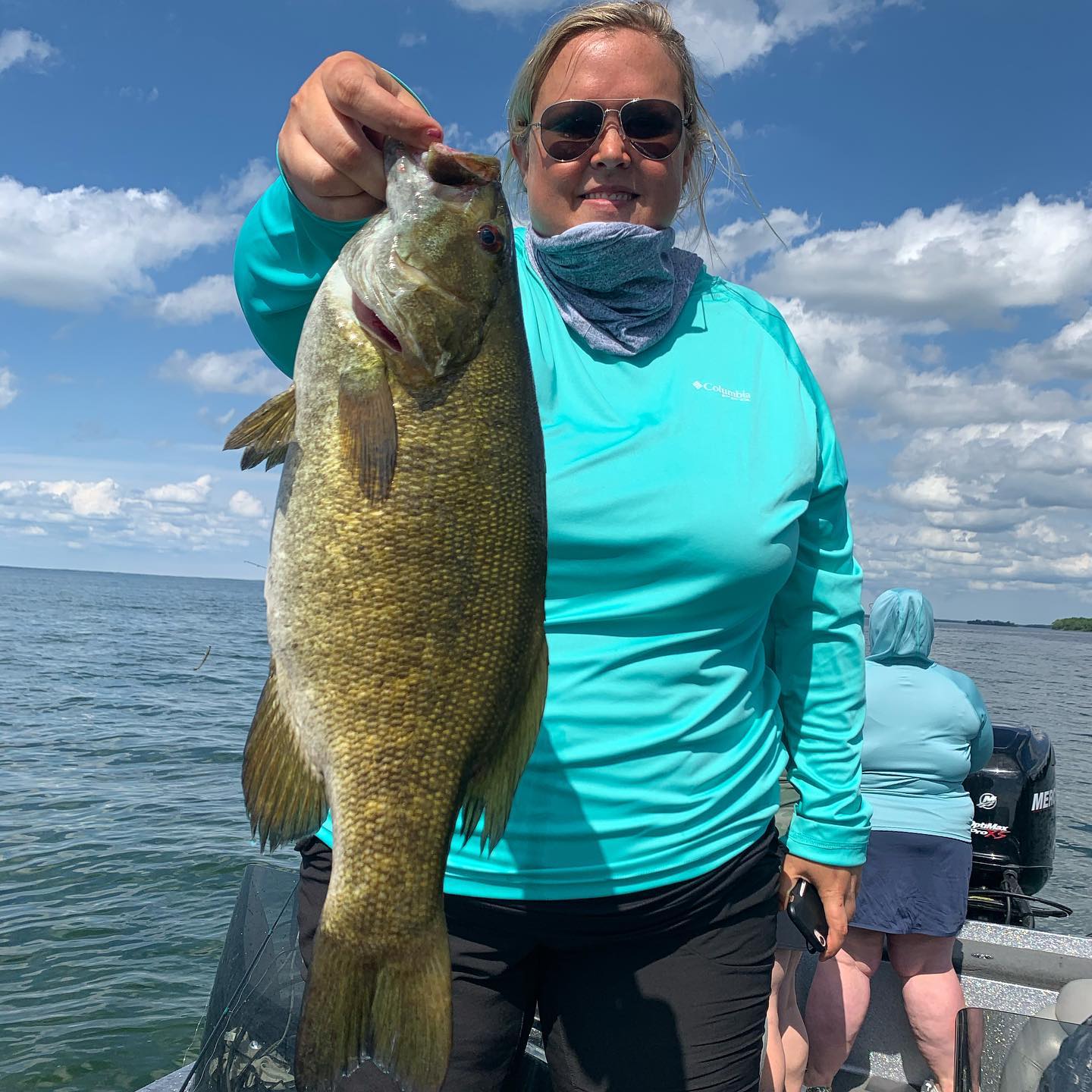 A single fisherman in the scenic Mille Lacs location, fishing with an unspecified technique.