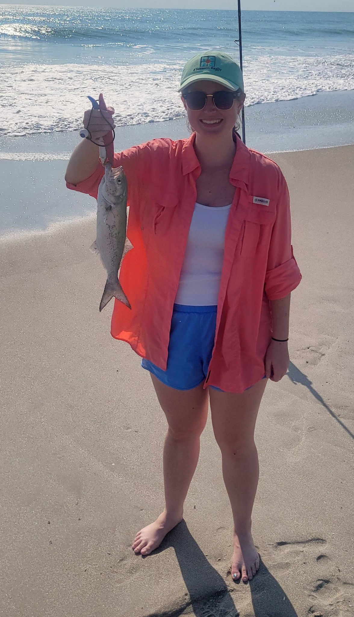 Freshly caught bluefish held up on beach in Melbourne FL after successful surf fishing trip