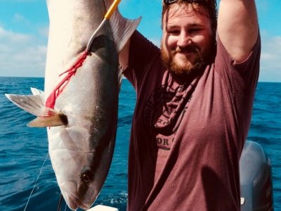 A person fishing in Sarasota, with a 17-inch catch