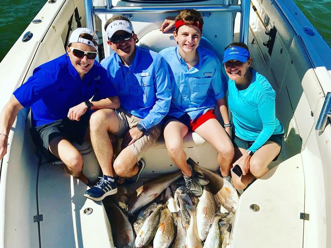 Galveston tarpon fishing charter boat with anglers targeting large fish in Texas coastal waters