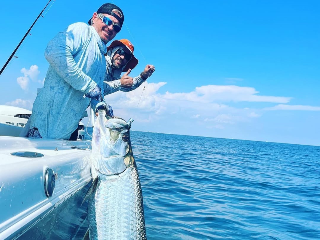 Galveston tarpon fishing charter boat targeting migrating fish during peak season near Texas coast