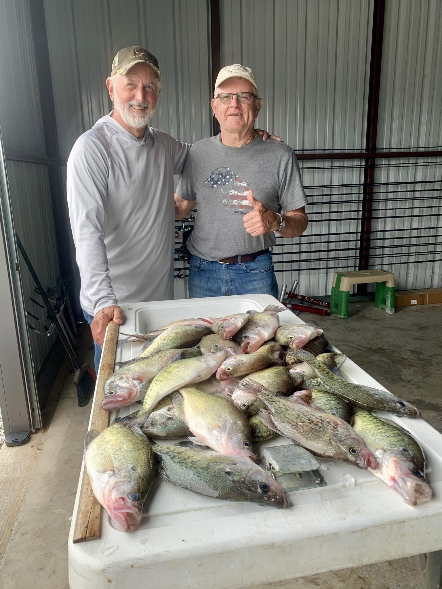 Fresh crappie catch displayed on cleaning table in Rogers AR fishing facility
