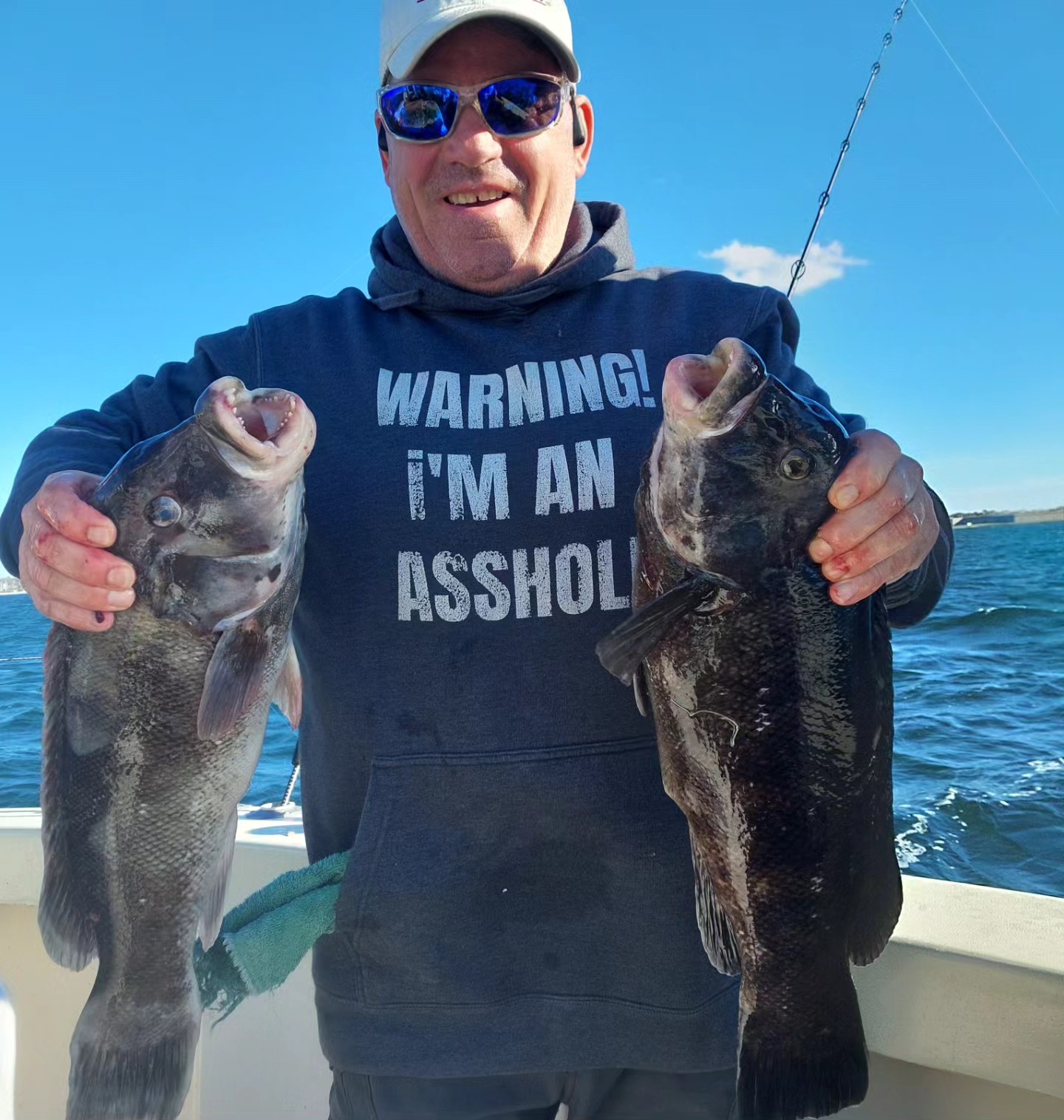Two anglers fishing in Newport, catching two fish
