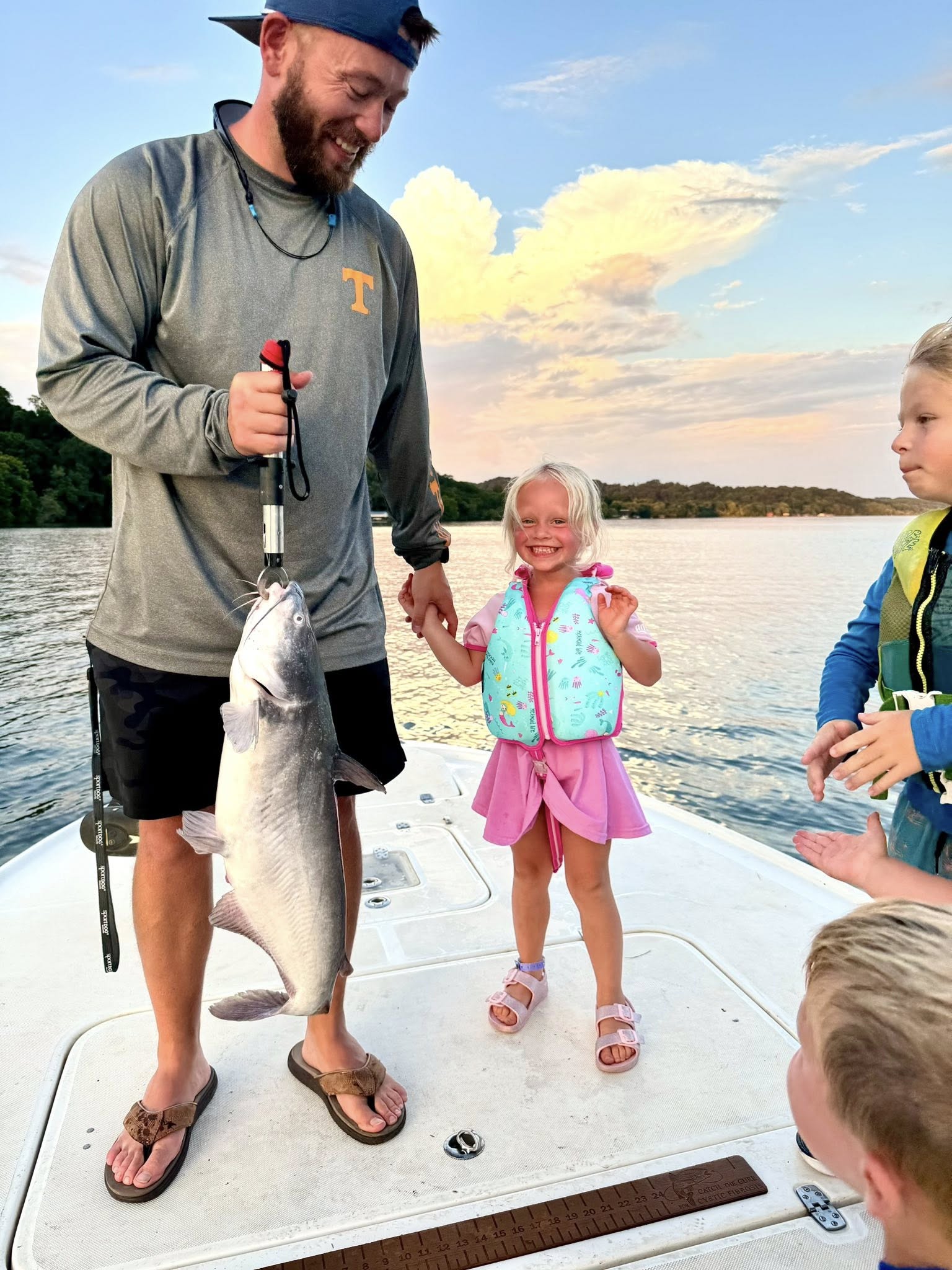 A group of 3 people fishing for a blue catfish in TN